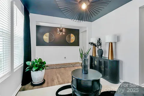 a dining room with furniture and potted plant