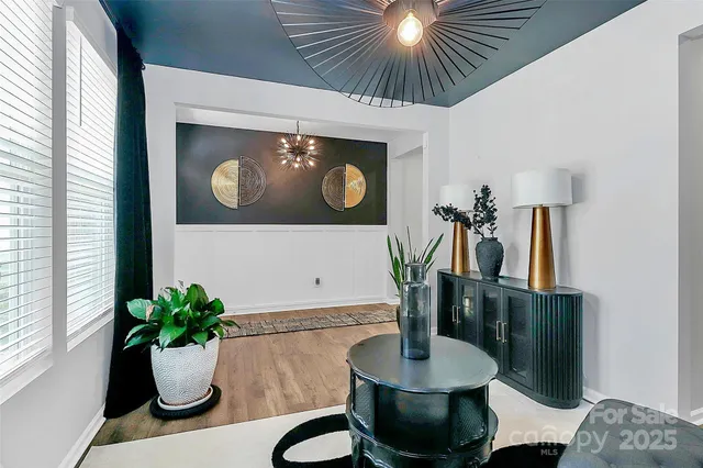 a dining room with furniture and potted plant
