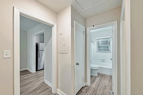 551 Wimbledon Road Northeast, Unit B Atlanta, GA 30324 - Photo 11 of 20 a view of a bathroom from a hallway with wooden floor