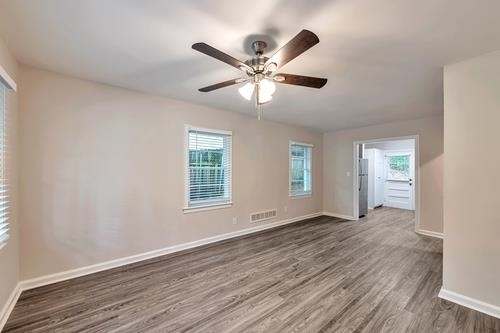 551 Wimbledon Road Northeast, Unit B Atlanta, GA 30324 - Photo 12 of 20 a view of an empty room with wooden floor and a window