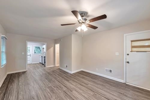 551 Wimbledon Road Northeast, Unit B Atlanta, GA 30324 - Photo 13 of 20 a view of empty room with wooden floor and fan