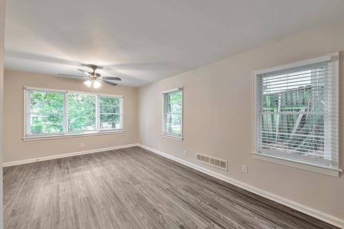 551 Wimbledon Road Northeast, Unit B Atlanta, GA 30324 - Photo 15 of 20 a view of an empty room with wooden floor and a window