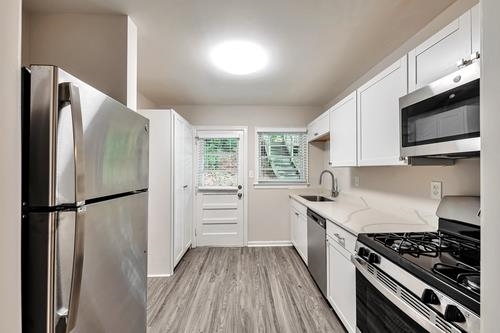 551 Wimbledon Road Northeast, Unit B Atlanta, GA 30324 - Photo 3 of 20 a kitchen with stainless steel appliances a refrigerator stove and microwave