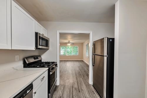 551 Wimbledon Road Northeast, Unit B Atlanta, GA 30324 - Photo 6 of 20 a kitchen with a refrigerator a stove and a microwave