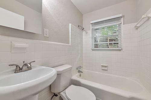 551 Wimbledon Road Northeast, Unit B Atlanta, GA 30324 - Photo 10 of 20 a white bath tub sitting next to a white toilet and sink