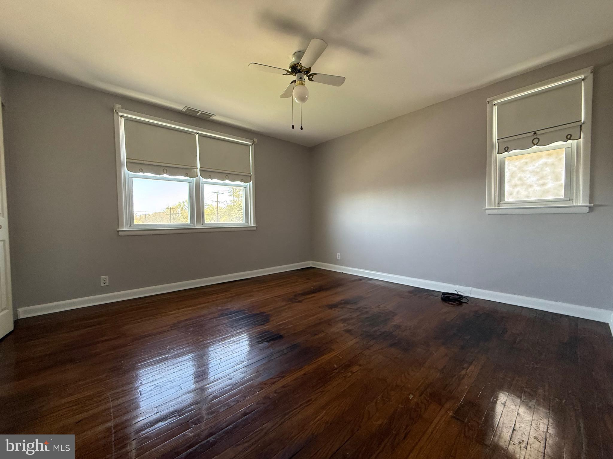 9083 Convent Avenue Philadelphia, PA 19136 - Photo 15 of 22 an empty room with wooden floor ceiling fan and windows