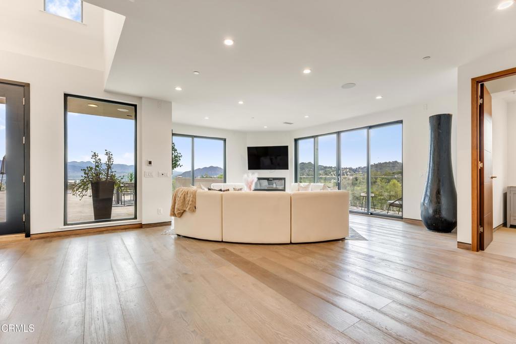 12480 Viewcrest Road Los Angeles, CA 91604 - Photo 16 of 69 a living room with furniture floor to ceiling window and wooden floor