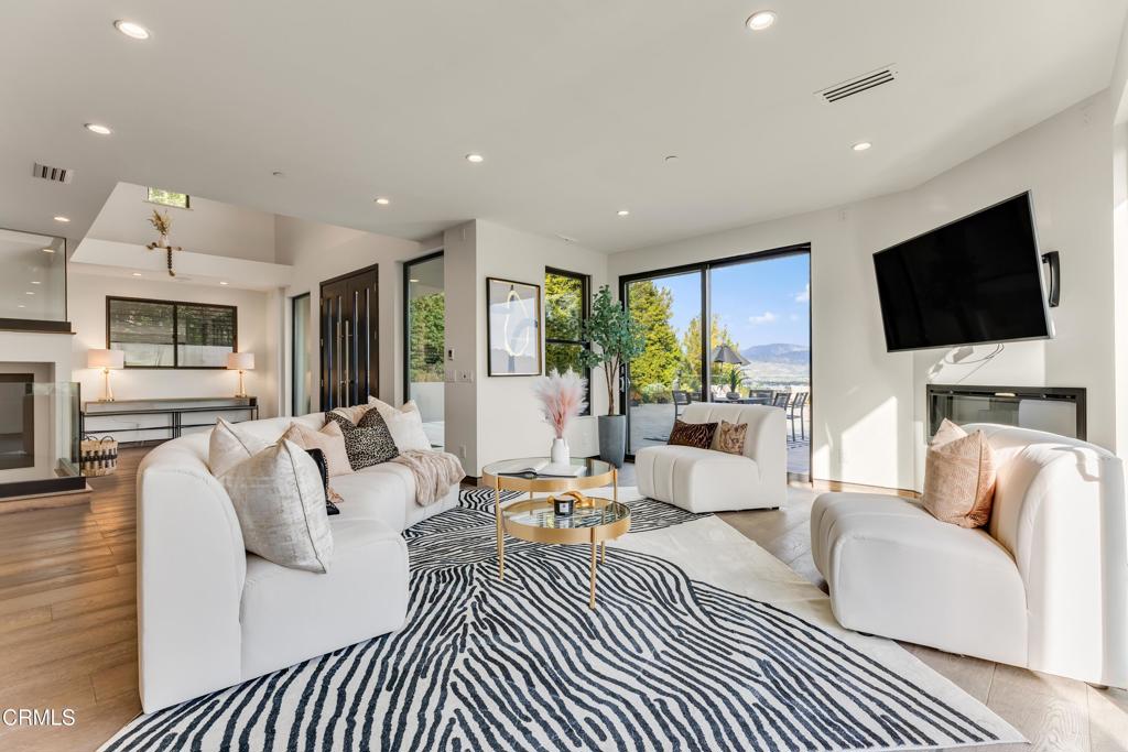 12480 Viewcrest Road Los Angeles, CA 91604 - Photo 18 of 69 a living room with fireplace furniture and a flat screen tv