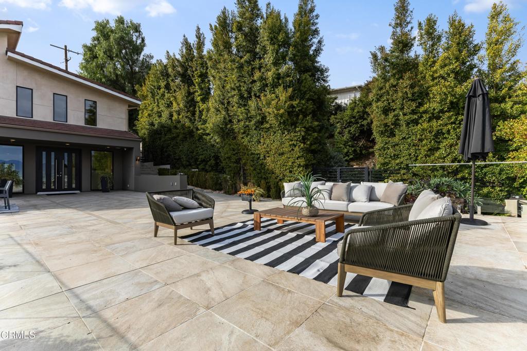12480 Viewcrest Road Los Angeles, CA 91604 - Photo 34 of 69 a roof deck with a table and chairs and potted plants