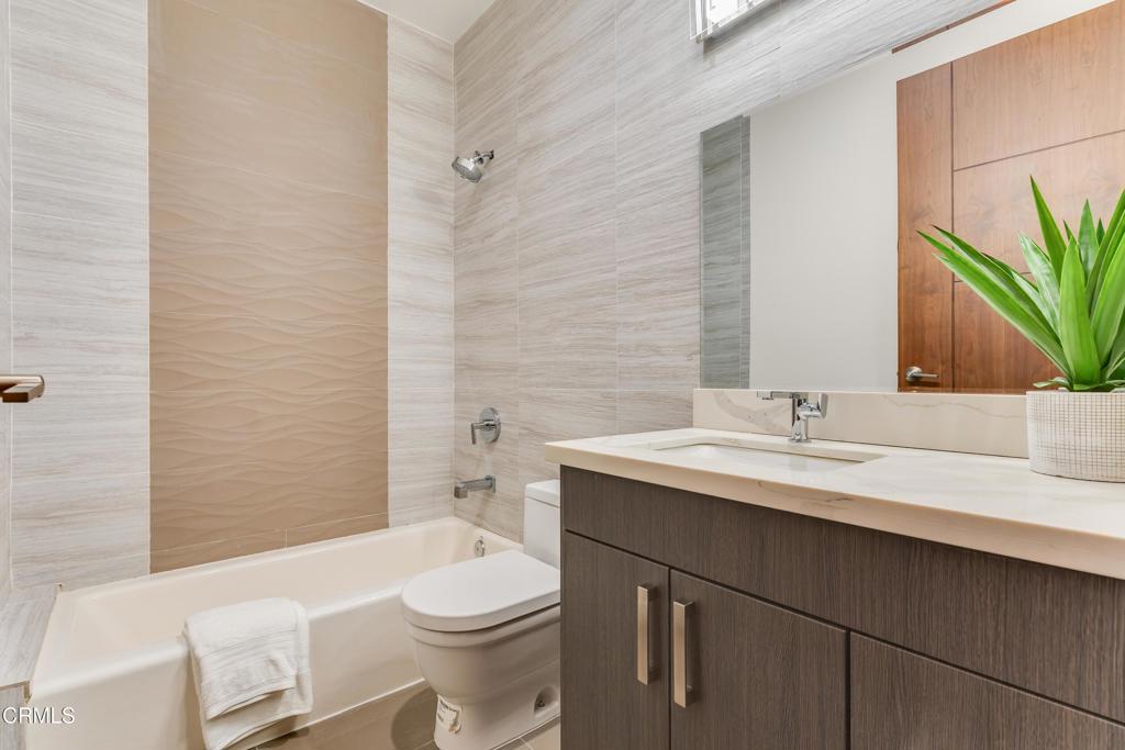 12480 Viewcrest Road Los Angeles, CA 91604 - Photo 43 of 69 a bathroom with a sink a toilet a mirror and vanity