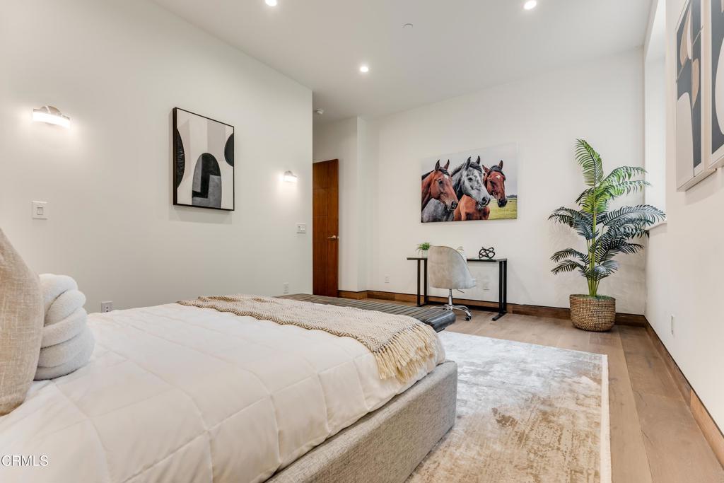 12480 Viewcrest Road Los Angeles, CA 91604 - Photo 46 of 69 a bedroom with a large bed and a potted plant