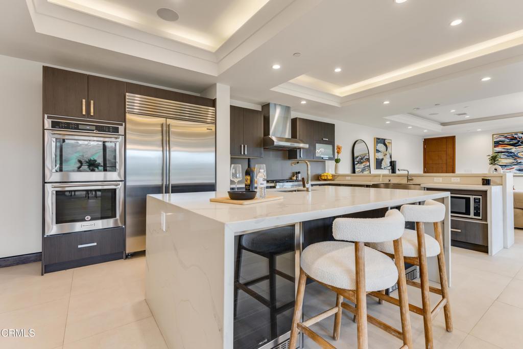 12480 Viewcrest Road Los Angeles, CA 91604 - Photo 58 of 69 a kitchen with a table chairs refrigerator and cabinets