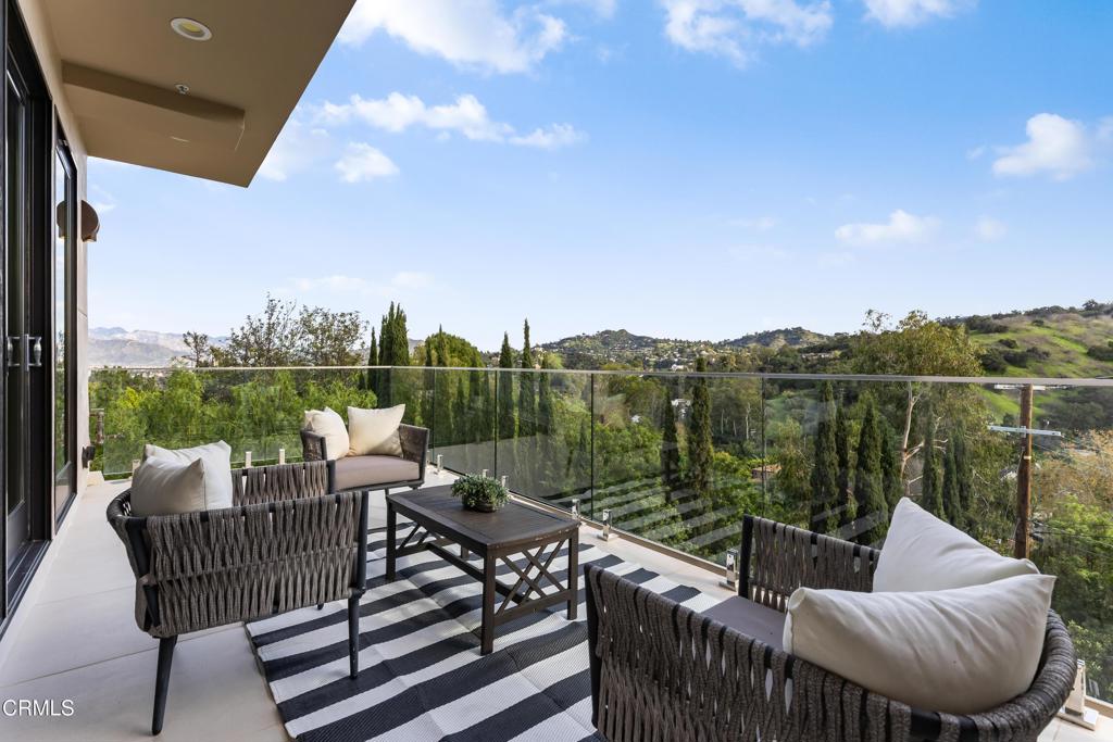 12480 Viewcrest Road Los Angeles, CA 91604 - Photo 61 of 69 a view of a terrace with couches and wooden floor