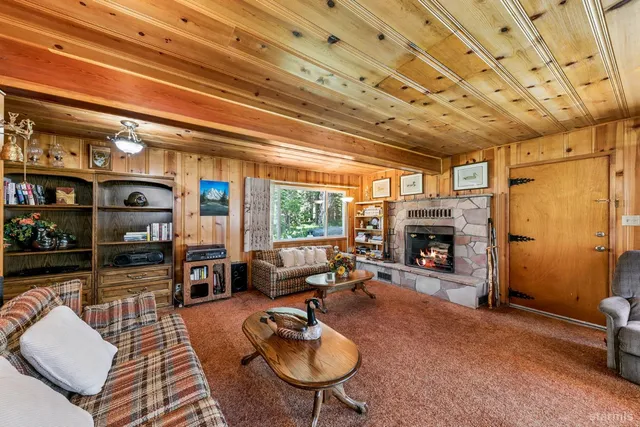 a living room with furniture a fireplace and a chandelier