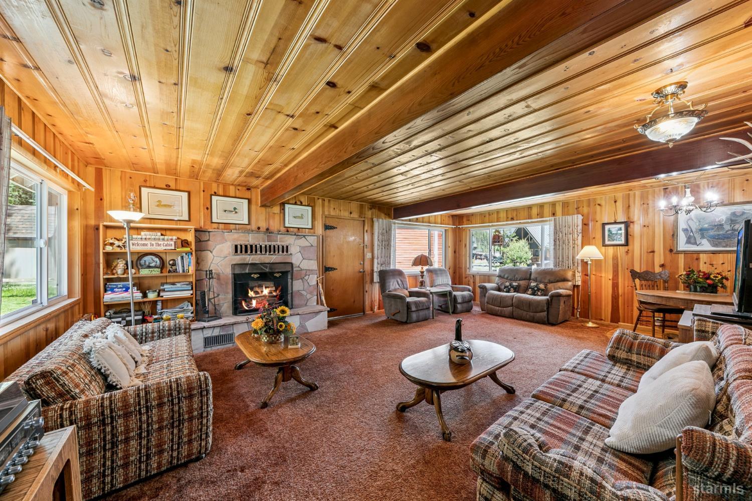7075 Mount Ralston Road Twin Bridges, CA 95735 - Photo 15 of 26 a living room with furniture a fireplace and a table