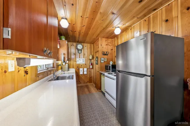 a kitchen with stainless steel appliances a refrigerator and a counter