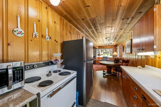 a bedroom with a bed a lamp and a large window