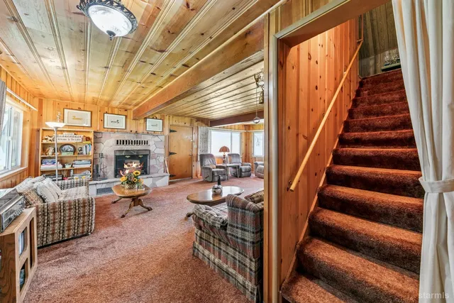 a bedroom with a bed a mirror on dresser and a chandelier