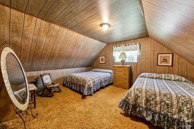 a bedroom with a bed and a night stand