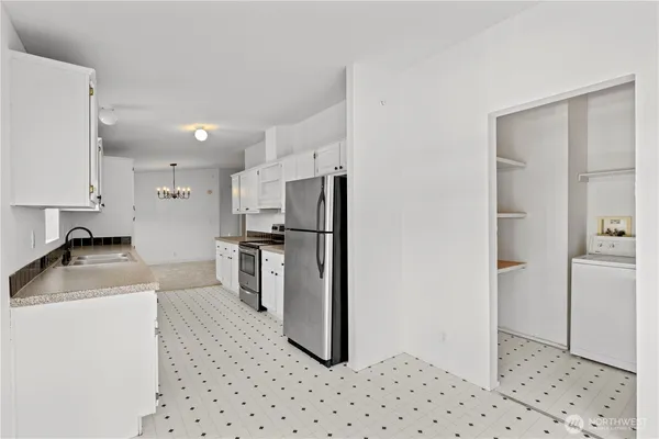 a kitchen with a refrigerator a stove and a sink