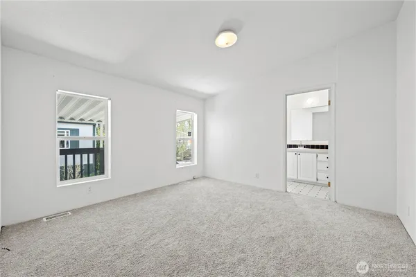 an empty room with windows and closet