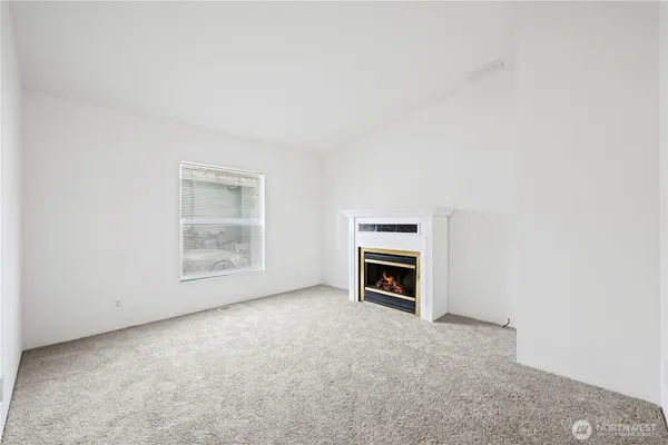 an empty room with a fireplace