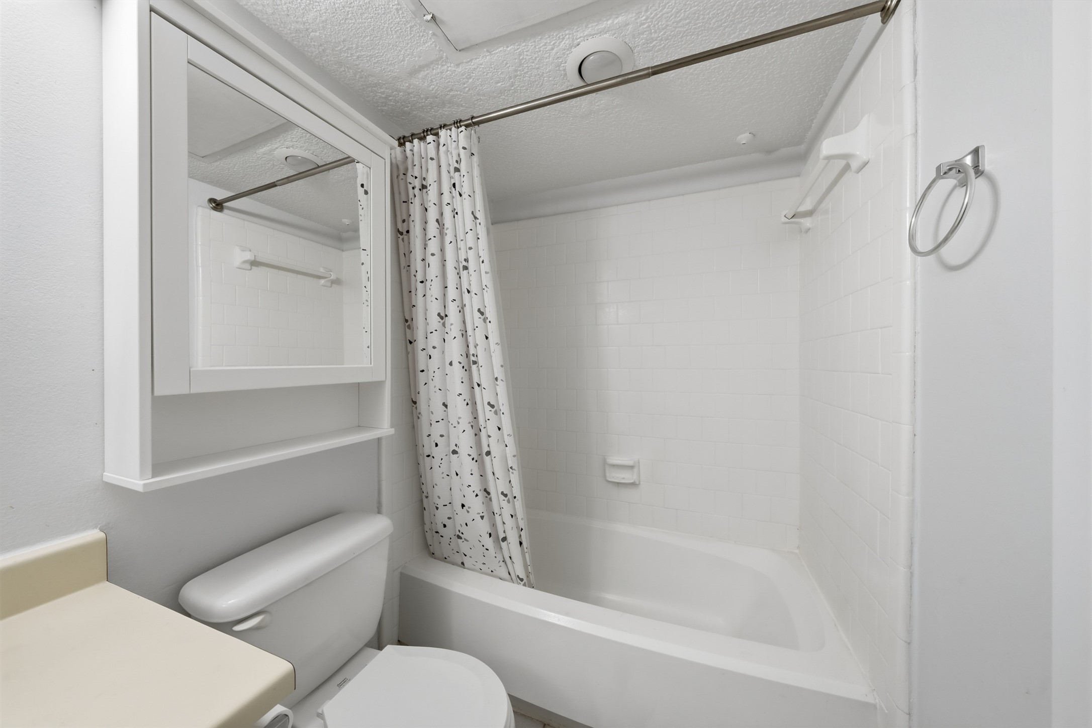 10855 Meadowglen Lane, Unit 823 Houston, TX 77042 - Photo 13 of 35 a bathroom with a shower curtain and a toilet