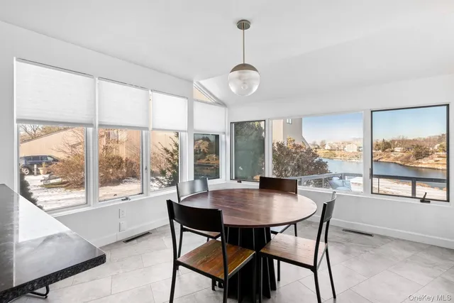 a view of a dining room with furniture large windows and wooden floor