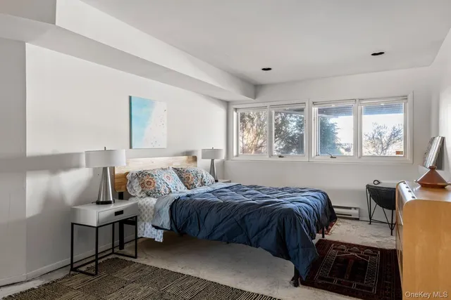 a bedroom with a bed and window