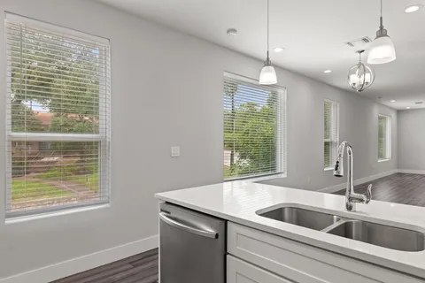a kitchen with a sink and large window