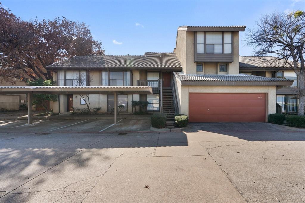 4533 North O'Connor Road, Unit 2208 Irving, TX 75062 - Photo 1 of 28 a front view of a house with a yard and garage