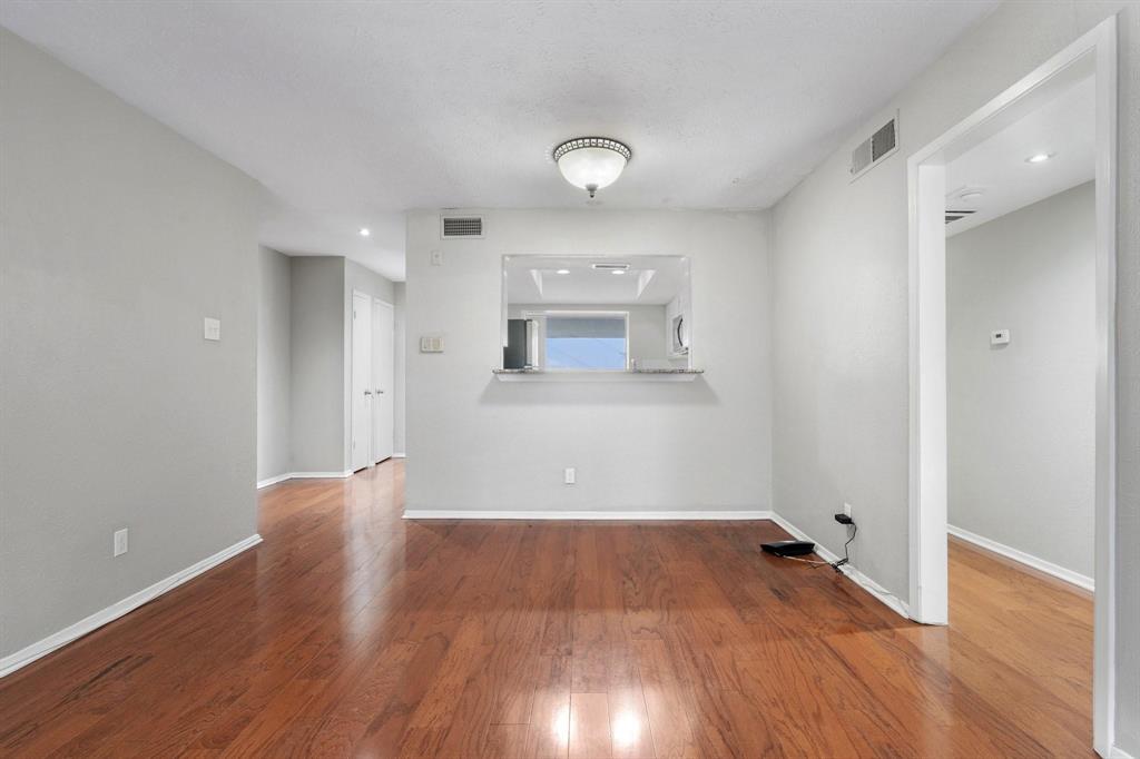 4533 North O'Connor Road, Unit 2208 Irving, TX 75062 - Photo 6 of 28 wooden floor in an empty room with a window