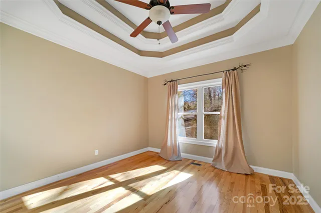 a bathroom with a granite countertop sink a toilet a mirror and shower