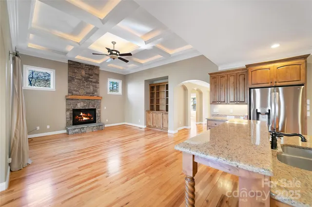 a large kitchen with stainless steel appliances wooden cabinets and a counter top space
