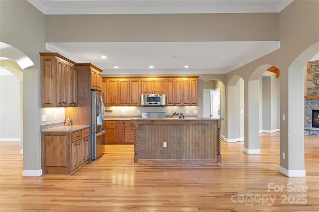 a kitchen with granite countertop wooden cabinets and stainless steel appliances