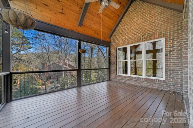 a view of a balcony with wooden floor and fence