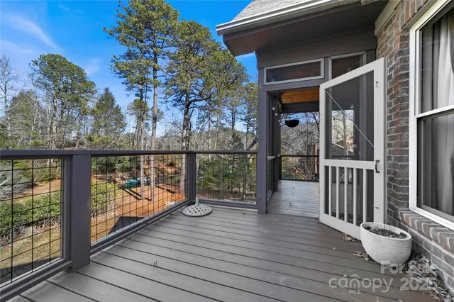 a view of room with window wooden floor and front door