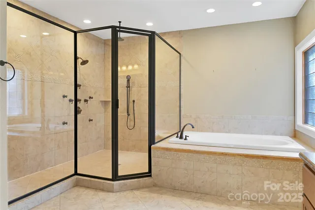 a spacious bathroom with a granite countertop sink a mirror and a shower
