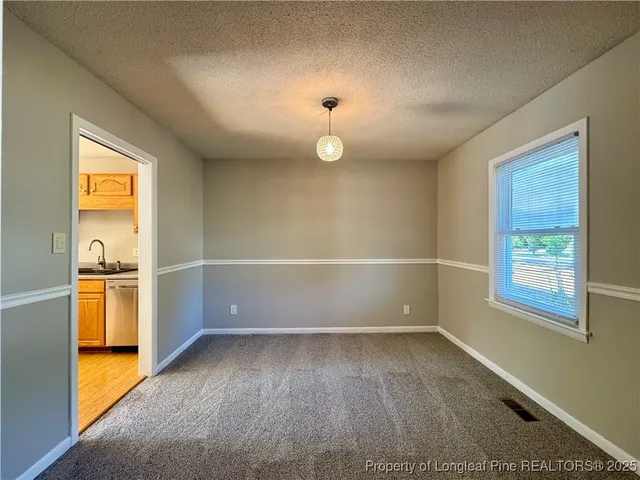 an empty room with windows and entrance