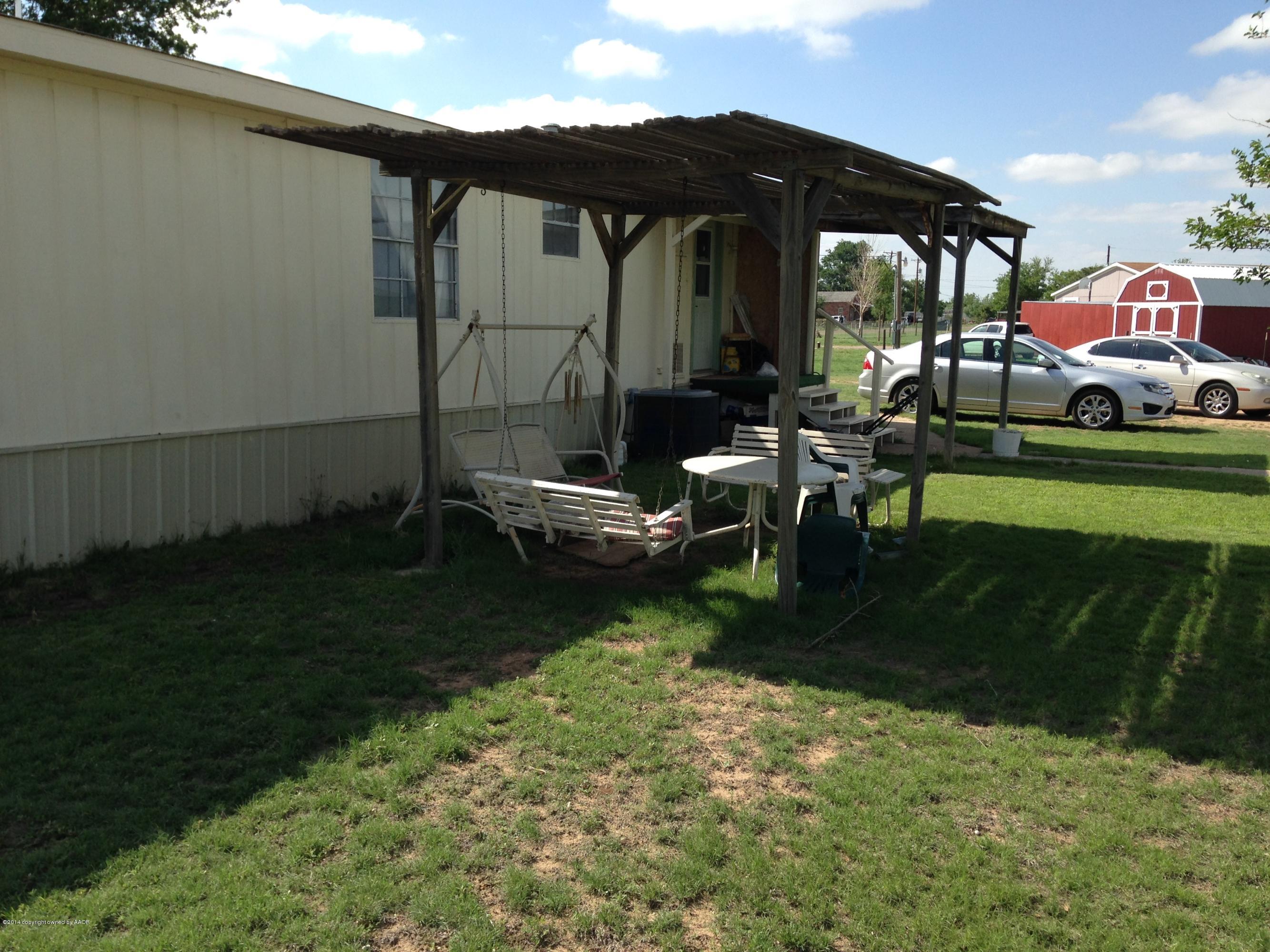 14175 Savannah Road Amarillo, TX 79118 - Photo 2 of 3 a backyard of a house with table and chairs