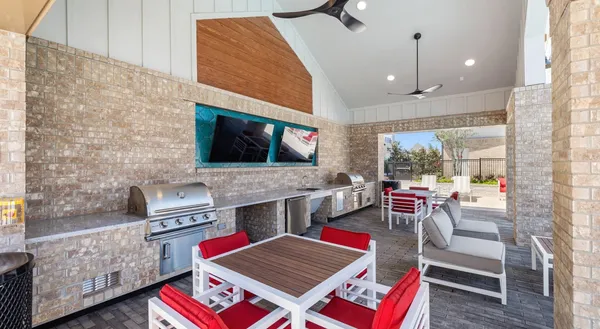 a living room with furniture a fireplace and windows