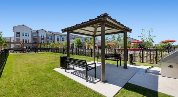 a view of a park with iron fence
