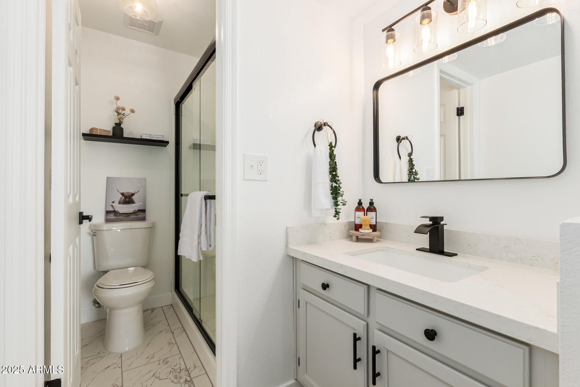 623 West Guadalupe Road, Unit 228 Mesa, AZ 85210 - Photo 1 of 14 a bathroom with a sink a toilet and a mirror
