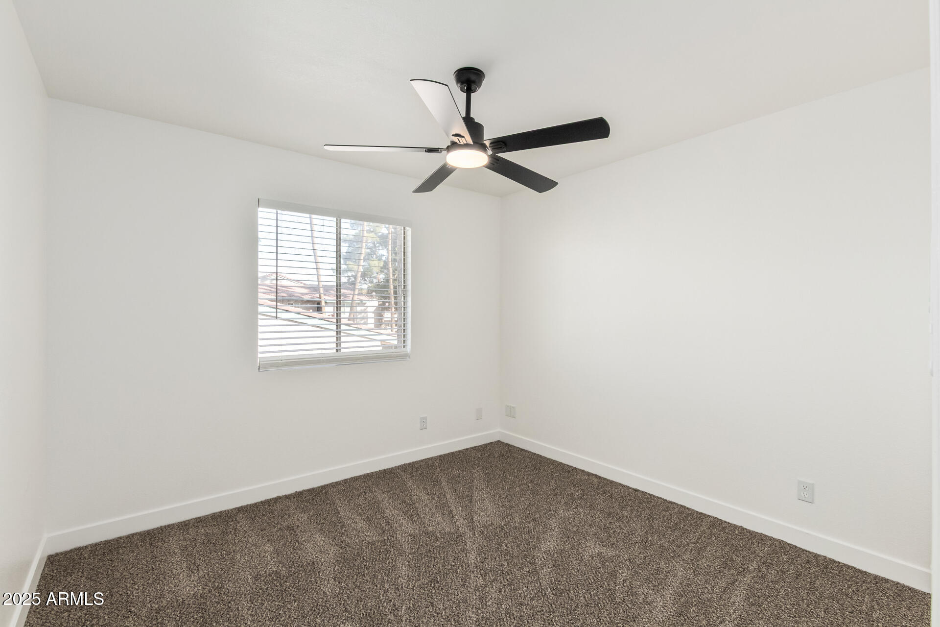 623 West Guadalupe Road, Unit 228 Mesa, AZ 85210 - Photo 11 of 14 an empty room with a window and a fan