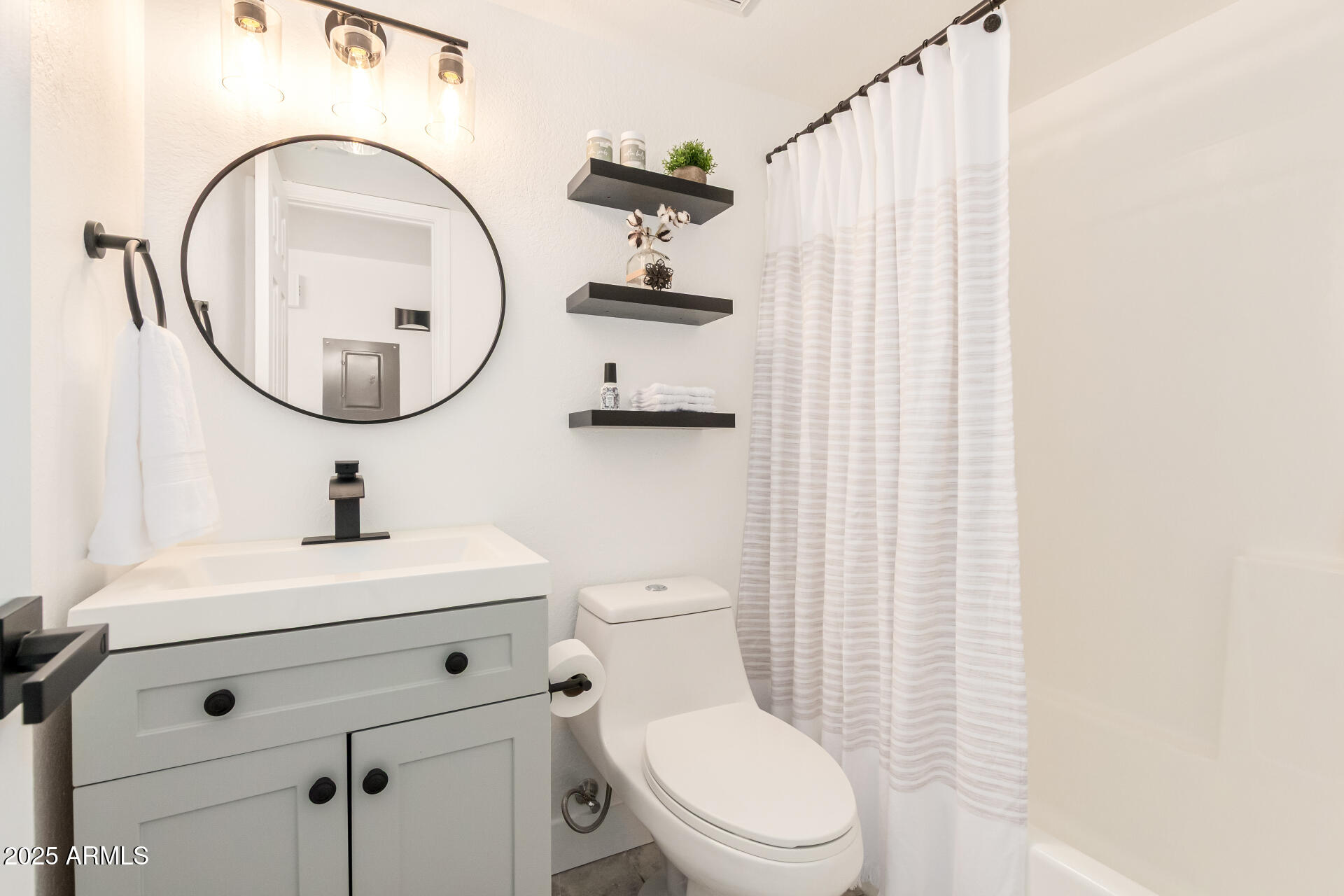 623 West Guadalupe Road, Unit 228 Mesa, AZ 85210 - Photo 2 of 14 a bathroom with a sink a toilet and a mirror