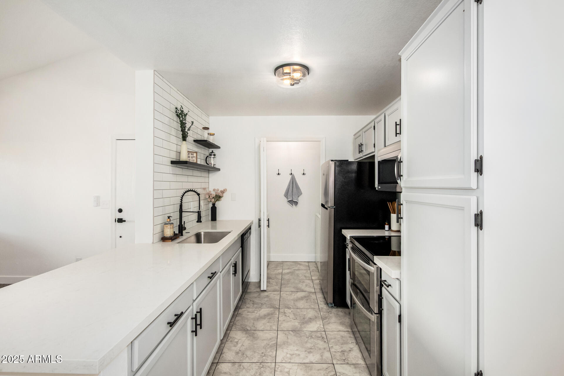 623 West Guadalupe Road, Unit 228 Mesa, AZ 85210 - Photo 5 of 14 a kitchen with a sink appliances and cabinets