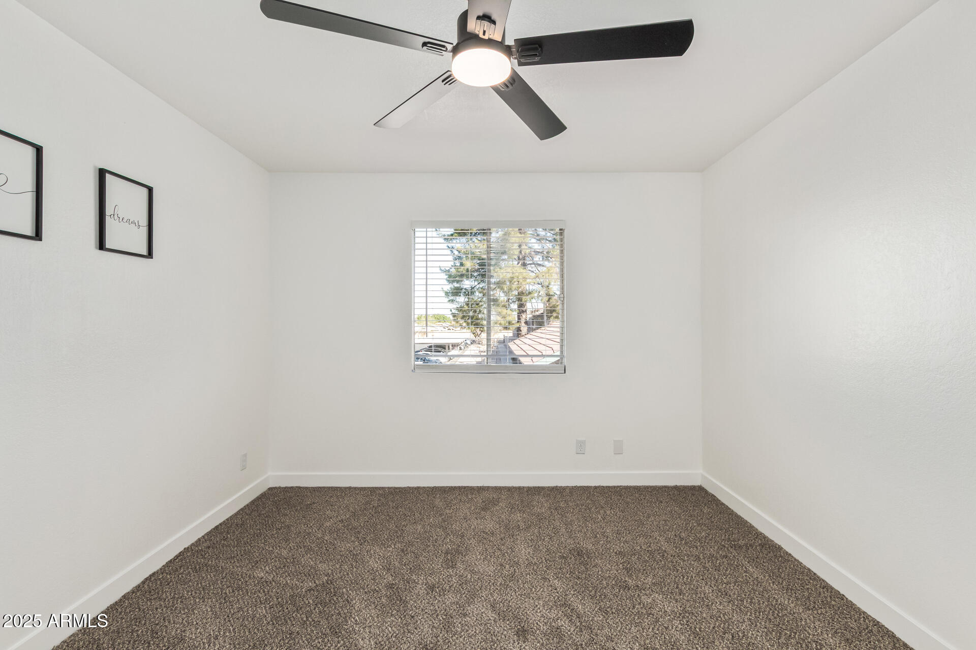 623 West Guadalupe Road, Unit 228 Mesa, AZ 85210 - Photo 9 of 14 an empty room with windows and fan