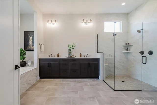 a bathroom with a sink mirror and shower