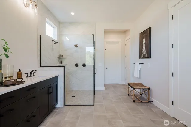 a spacious bathroom with a double vanity sink a mirror and a bathtub