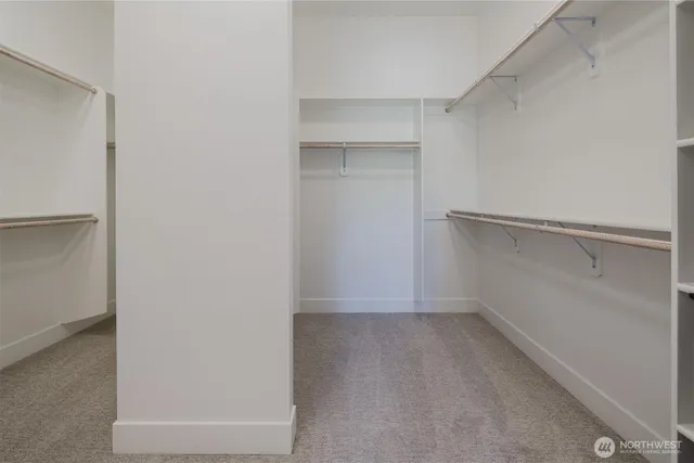 a view of walk in closet with empty racks